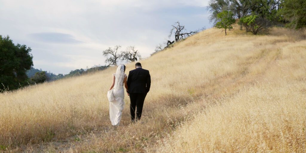 bride and groom walking through hills of Sonoma County